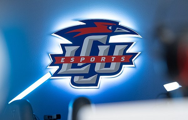 Backlit LCU Esports logo mounted on wall